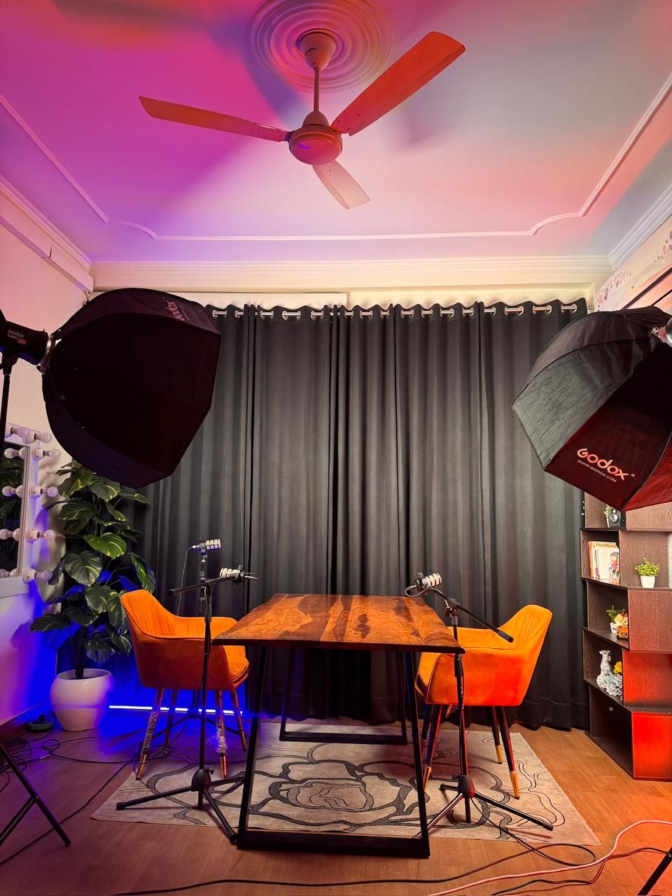 Podcast studio in Delhi with RGB accent lighting, Godox SL60IID softboxes and dark curtain backdrop